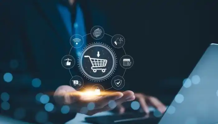 A digital business concept graphic representing E-commerce and Retail Industries by Grow Factor LLC, showing a professional working on a laptop while a glowing circular interface hovers over their hand, featuring a central shopping cart icon ringed by omnichannel retail symbols like Wi-Fi, a globe, marketing, storefront, security shield, shopping bag, delivery truck, and customer ratings.