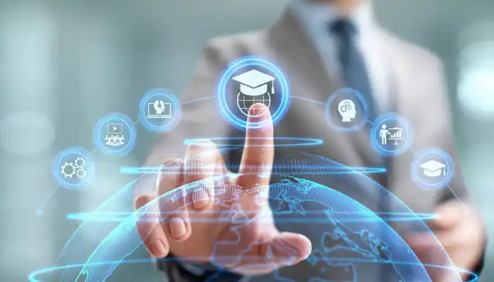 An e-learning technology concept graphic representing Education and Training Industries by Grow Factor LLC, showcasing a businessman in a suit pointing at a glowing digital interface. The interface arches over a virtual globe and features a central graduation cap icon on a sphere, surrounded by web icons for online learning, audio lessons, technical skills, human intellect, corporate coaching, and certifications.