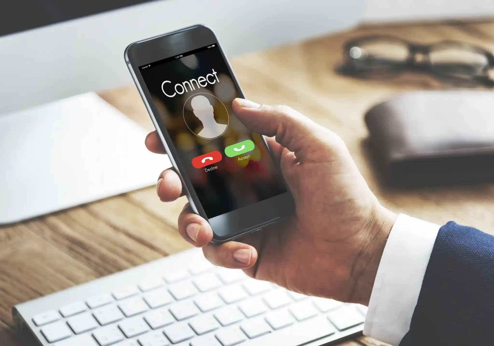 A call-to-action banner for Growfactor encouraging clients with the message "Let’s Rank your Website at the Top of Search Results," showing a close-up of a business professional holding a smartphone displaying an incoming call screen with a "Connect" header over a wooden office desk.